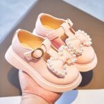 pink moccasin for little girl on one hand