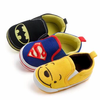 On a white background, three canvas moccasins featuring Batman in black, Spiderman in blue and Winnie the Pooh in yellow.