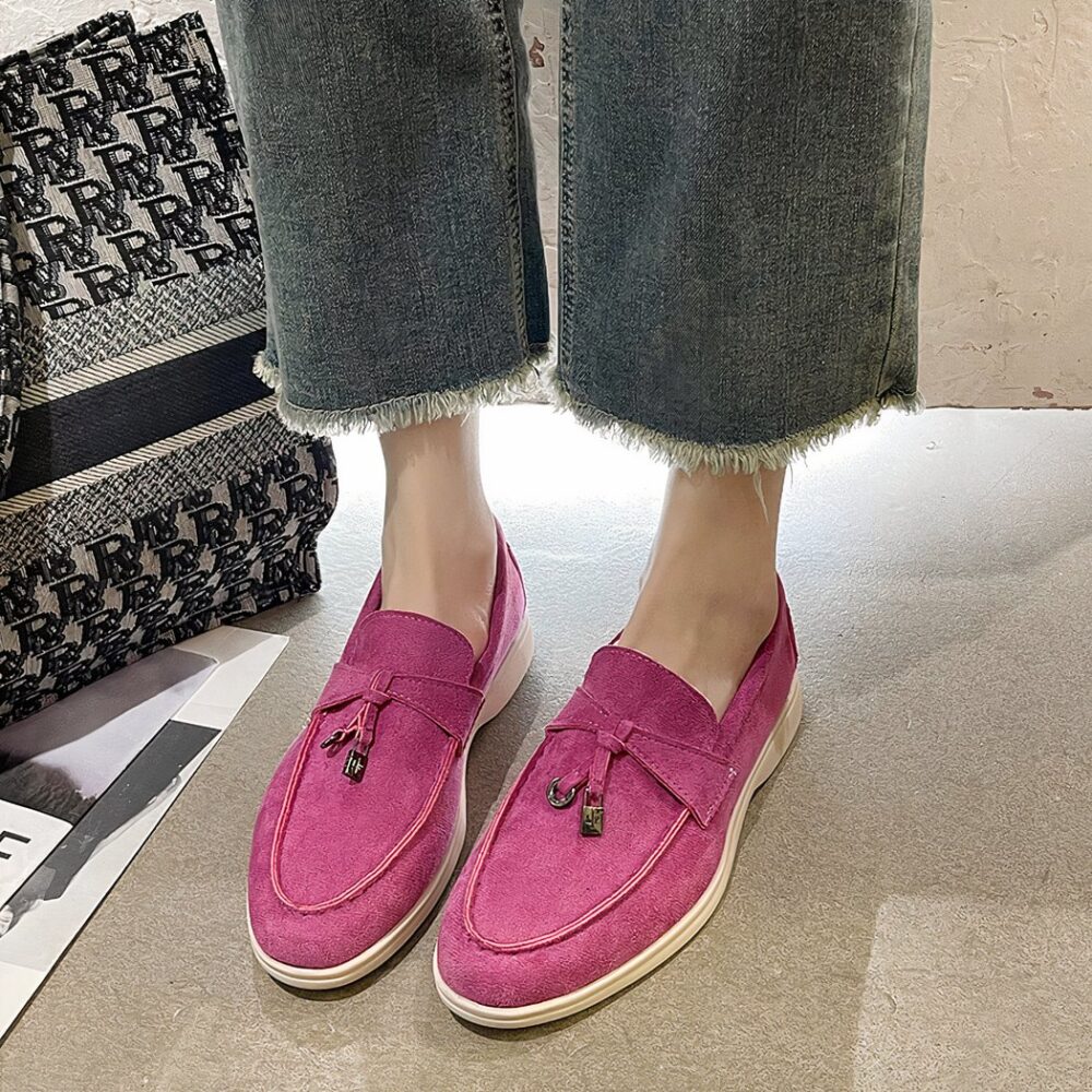 pink suede moccasin worn by a woman