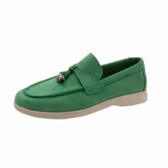Moccasin in green suede with a beige sole on a white background