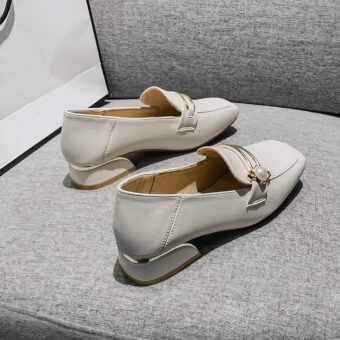white PU moccasin with a small heel on a grey sofa
