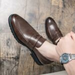 brown leather moccasin worn by a man