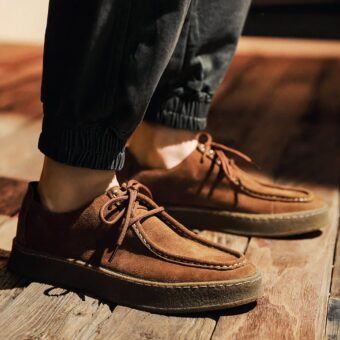 PHoto of a modern Indian-style moccasin in brown suede, worn by a man with jeans
