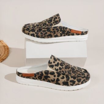 Shown in profile, pair of leopard print canvas round sport moccasins with thick white soles. One shoe on a white display and one underneath on a white floor