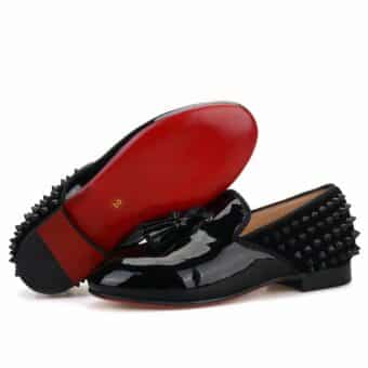 Black patent loafers with spikes at the back of the shoe.