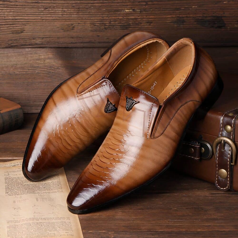 Pair of gradient brown moccasins on a vintage brown suitcase and parquet floor