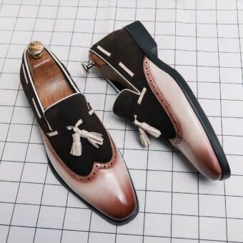 White and brown gradient loafers on white checkered floor