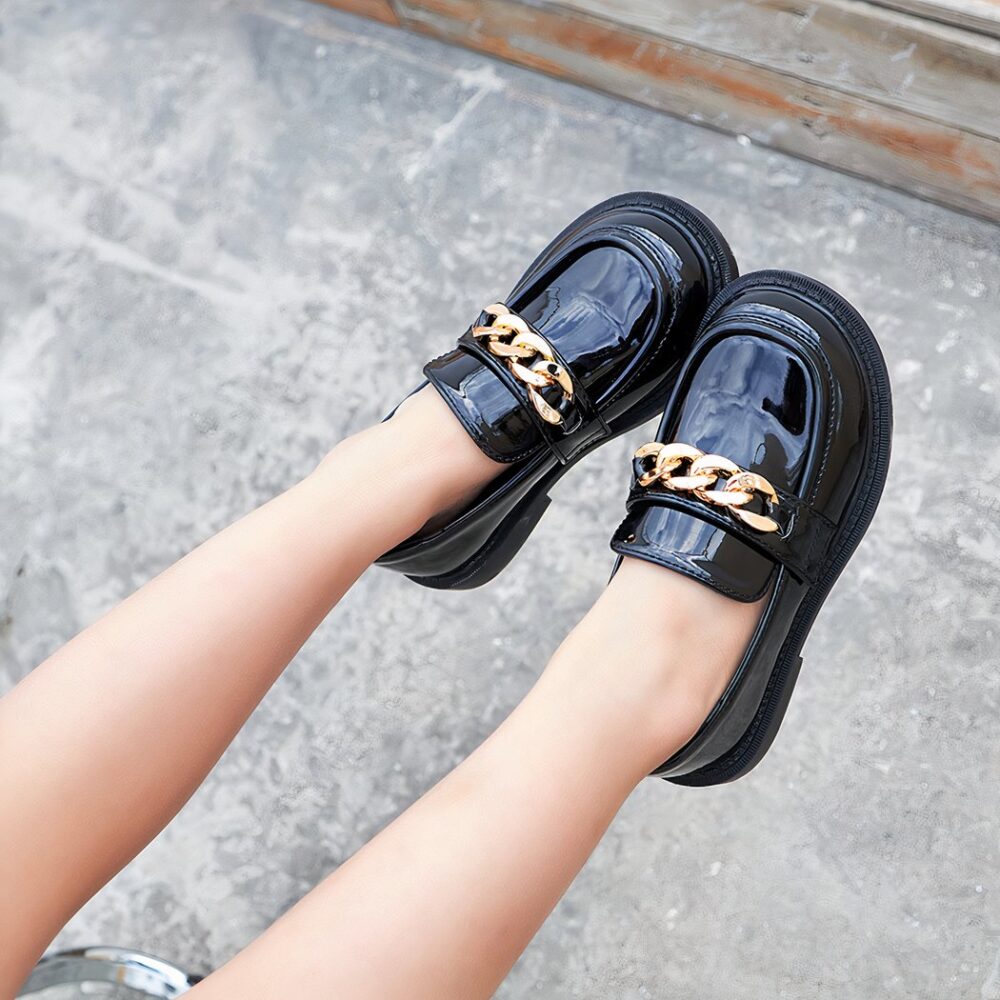 girl wearing black tassel patent shoes