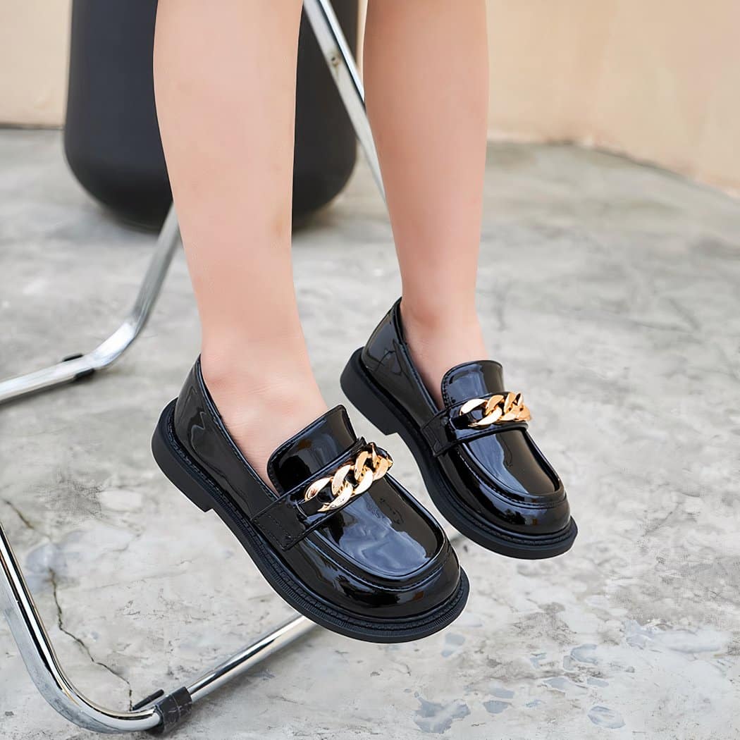 girl wearing polyurethane moccasin with black chain