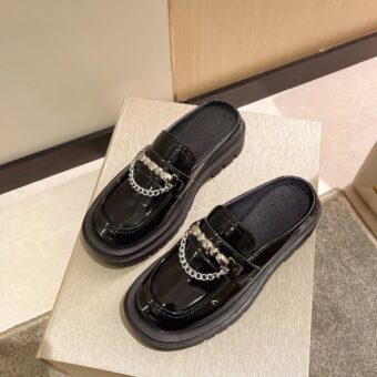 Photo of a pair of black platform loafers on a white box