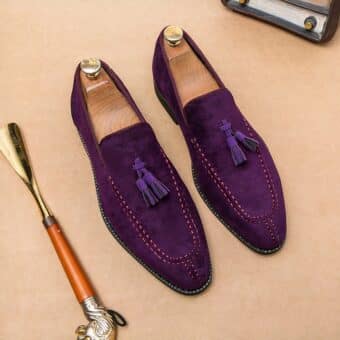 Pair of purple moccasins with tassels and a side shoe.