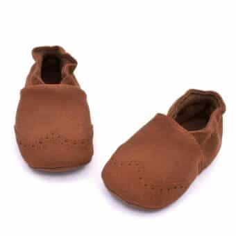 Brown faux leather baby moccasin on a white background