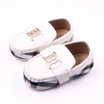 Pair of white baby moccasins with burberry check fabric turn and gold letter B on top.