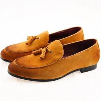 Pair of brown suede loafers on a white background