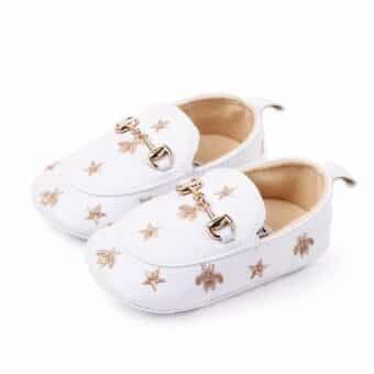 White faux leather moccasin with star motif and ring in the middle