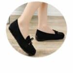 black suede moccasin on women's feet
