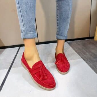 Woman wearing red leather moccasin with tassel