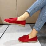 red suede fringe moccasin worn by a woman