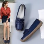 blue leather moccasin worn by a woman