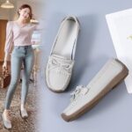 grey leather moccasin worn by a woman