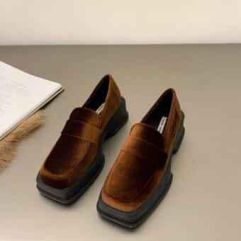 wedge moccasin in brown velvet with square edge set on grey ground