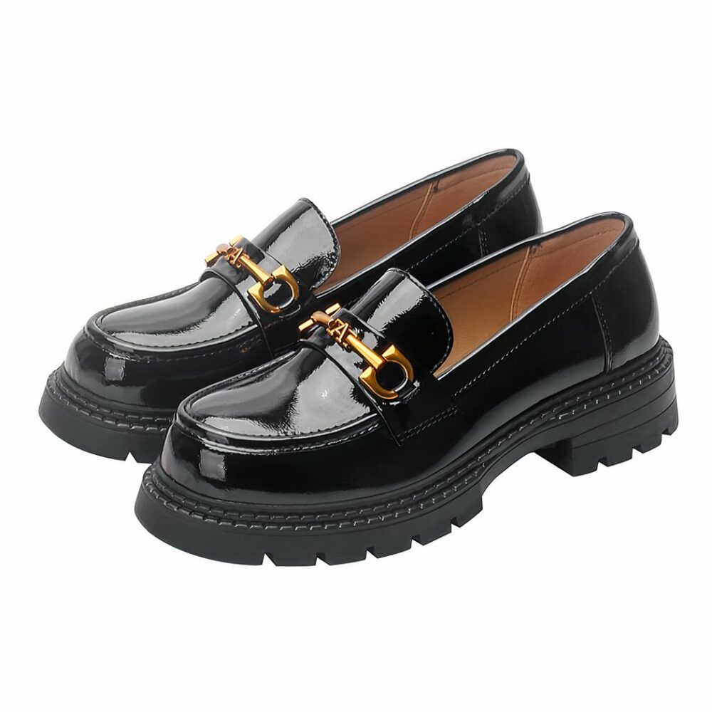Photo of a pair of black patent leather loafers on a white background
