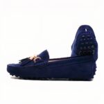 Photo of a pair of dark blue moccasins on a white background