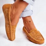 brown suede moccasin worn by a woman