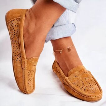 brown suede moccasin worn by a woman with an ankle bracelet