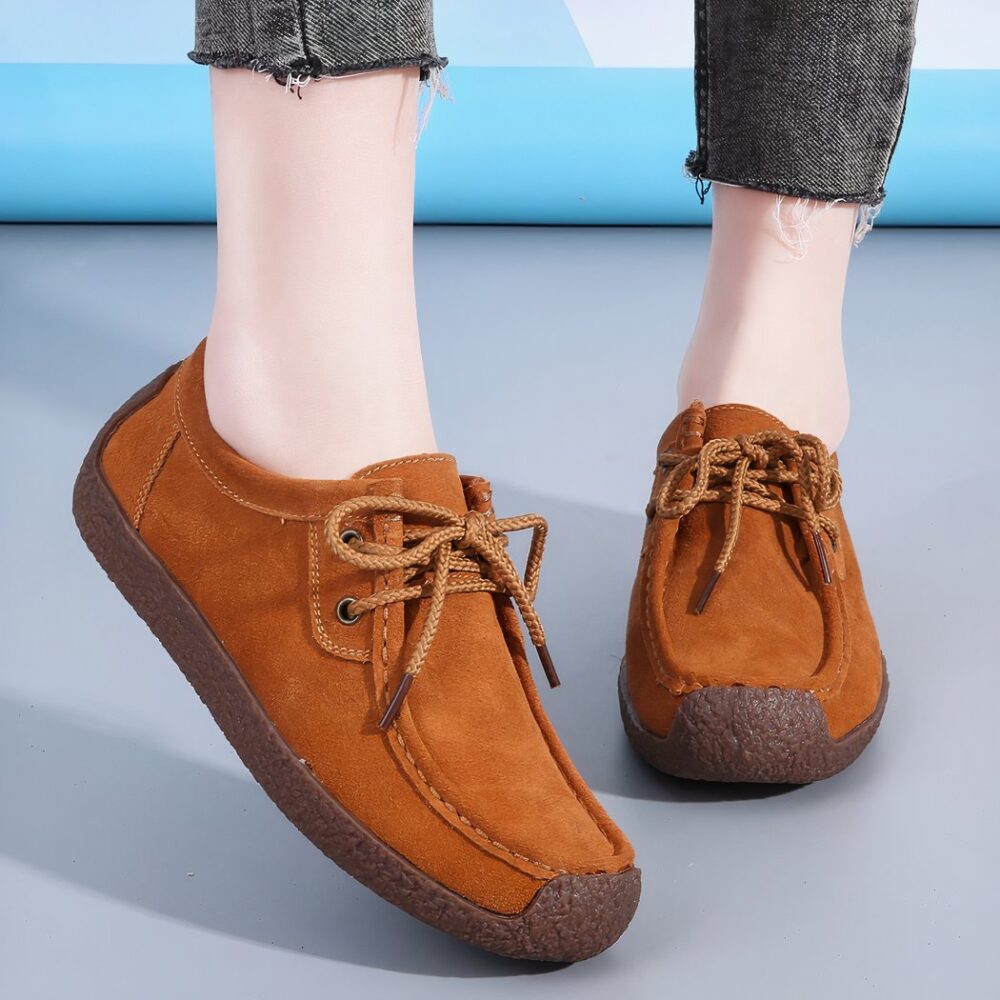 brown suede lace-up moccasin worn by a woman