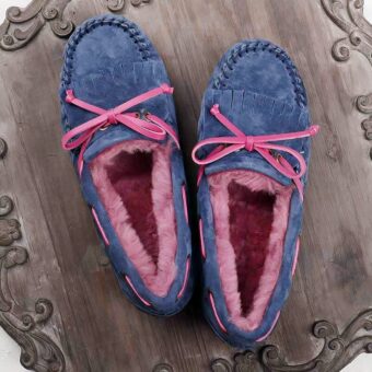 purple and pink moccasin in furry suede on a grey floor