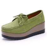 Photo of a green platform loafer on a white background