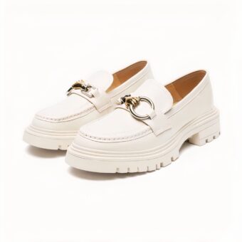 Photo of a pair of beige moccasins on a white background