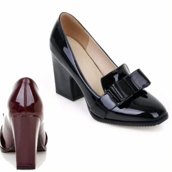 two patent leatherette heeled loafers, one black one burgundy, on a white background