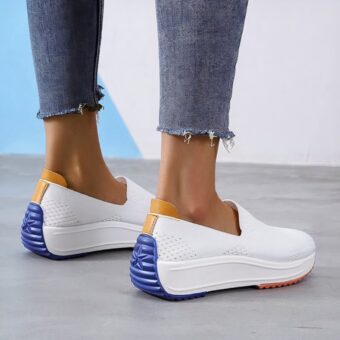 Photo of orthopedic sneaker-type moccasins in breathable white mesh with a colored sole right down to the back of the heel.