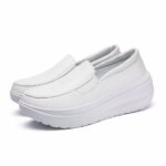 Photo of a pair of white, leather, platform orthopedic moccasins.