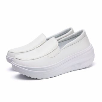 Photo of a pair of white, leather, platform orthopedic moccasins.
