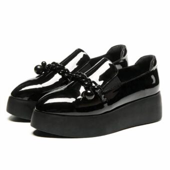 Women's glossy black loafers with small tassels and wide sole