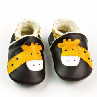 Soft baby moccasins in dark brown leather with yellow giraffe head. Soft beige plush is visible inside.