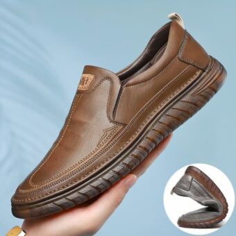 Photo of a brown leather orthopedic moccasin with ultra-soft sole in one hand and a bubble showing the flexibility of the shoe.