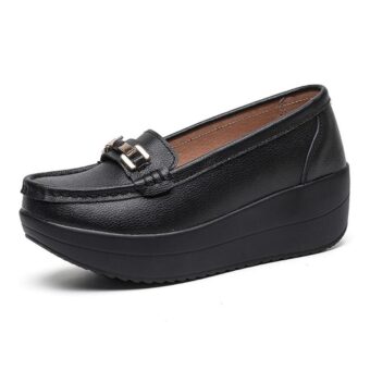 Black loafer with thick profile sole and gold buckle on front