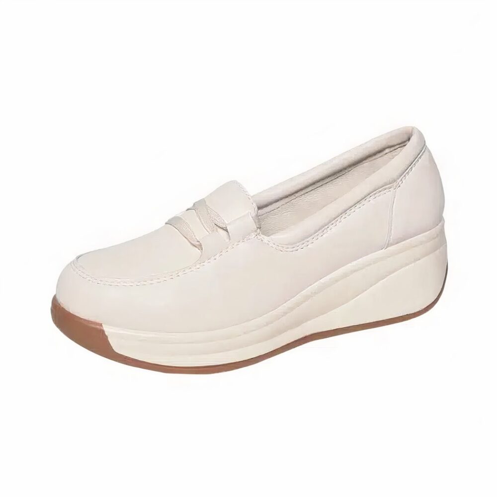 White moccasin with wedge heels on a white background.