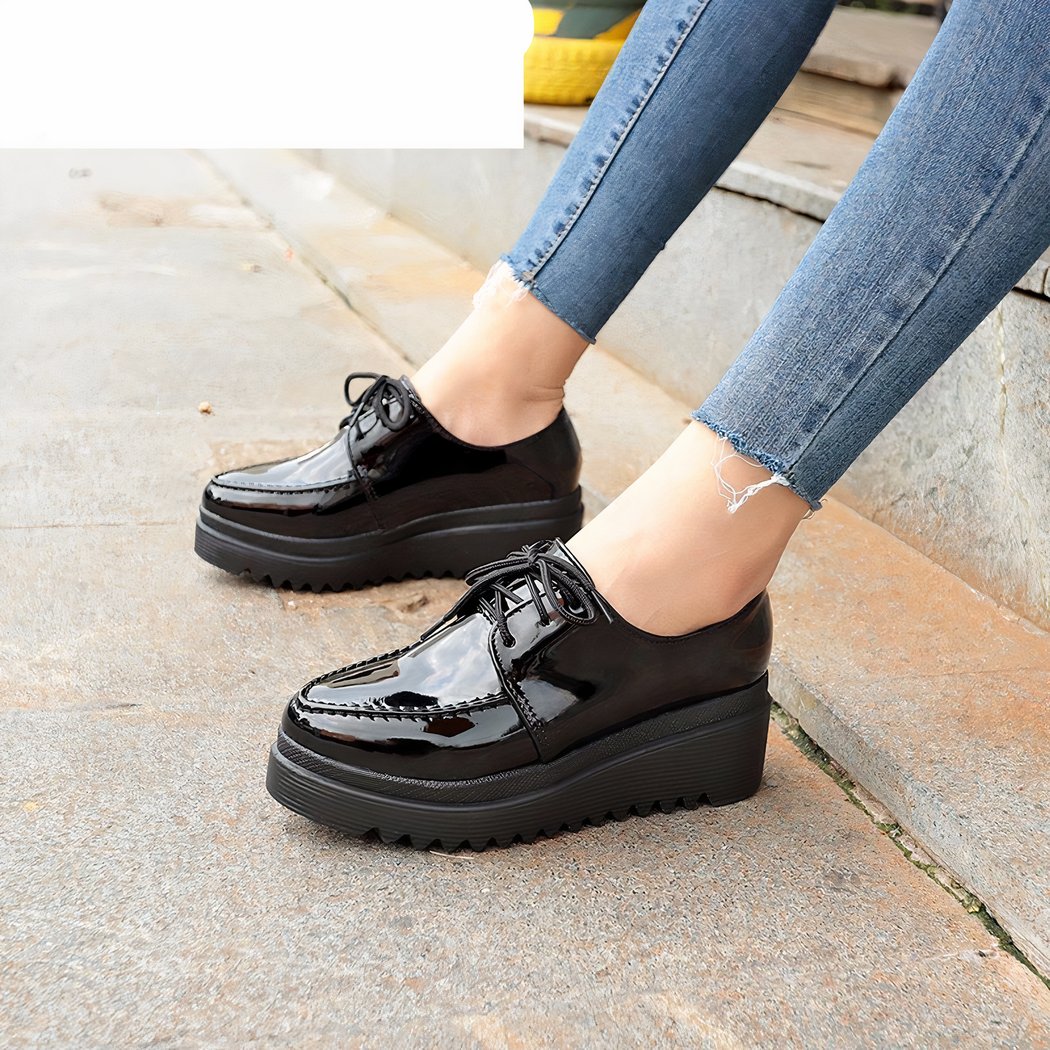 woman wearing black wedge moccasin