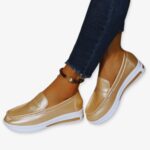 Photo of shiny gold wedge loafer sneakers