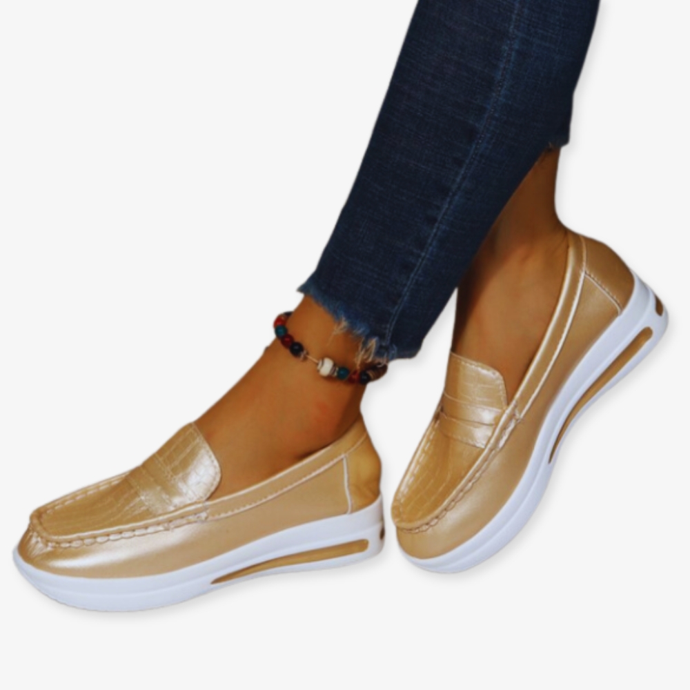 Photo of shiny gold wedge loafer sneakers