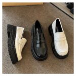 On grey carpet 3 moccasins in white and black they shine