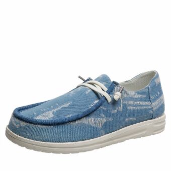 Boat-style loafer with blue denim laces on a white background
