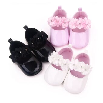 Three pairs of moccasins with flowers on a white background, in black, pink and white