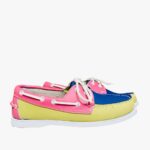 Yellow, pink and blue boat moccasins, placed in profile on a grey floor