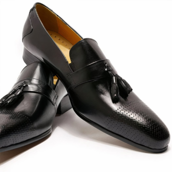 Women's glossy black tassel loafer on white background